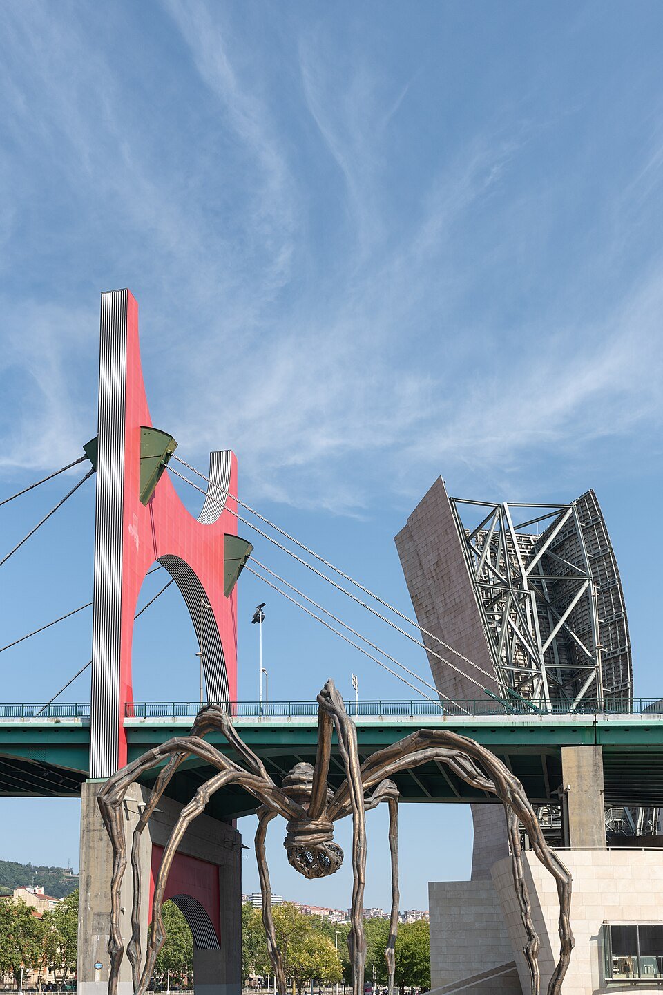 Long spider legs of Maman framing the space beneath its body in Bilbao.